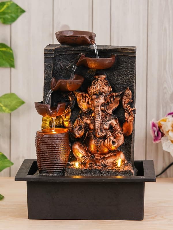 - CHRONIKLE Polyresin Golden Brown Ganesha Tabletop Indoor 4 Diya Steps Waterfall Fountain for Home Décor with Yellow LED Light & Water Flow Controller Pump (Size: 39 x 29.5 x 22CM | Weight: 2195grm)